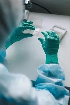 Crop hands putting microscope glasses in box Stock Photos
