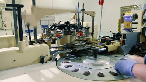 Crop hands putting sweets into wrapping machine. Hands of unrecognizable female Video stock 98011961