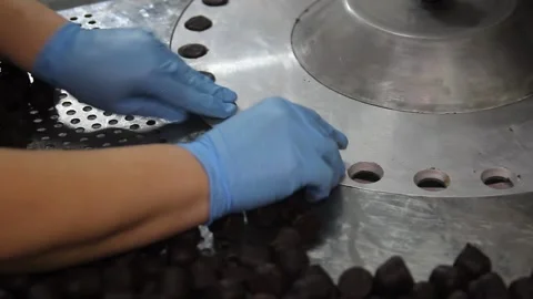 Crop hands putting sweets into wrapping machine. Hands of unrecognizable female Stock Footage 148349107
