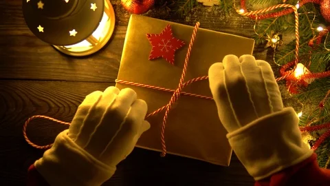 Crop hands of Santa tying gift near lamp Stock Footage 101604428