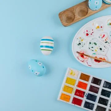 Crop image of flat lay composition with easter eggs and paints Stock Photos