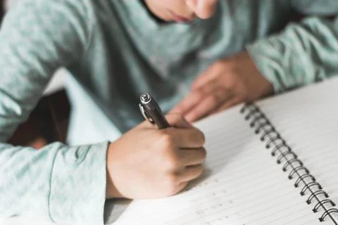 Crop kid writing notebook. High quality photo Stock Photos