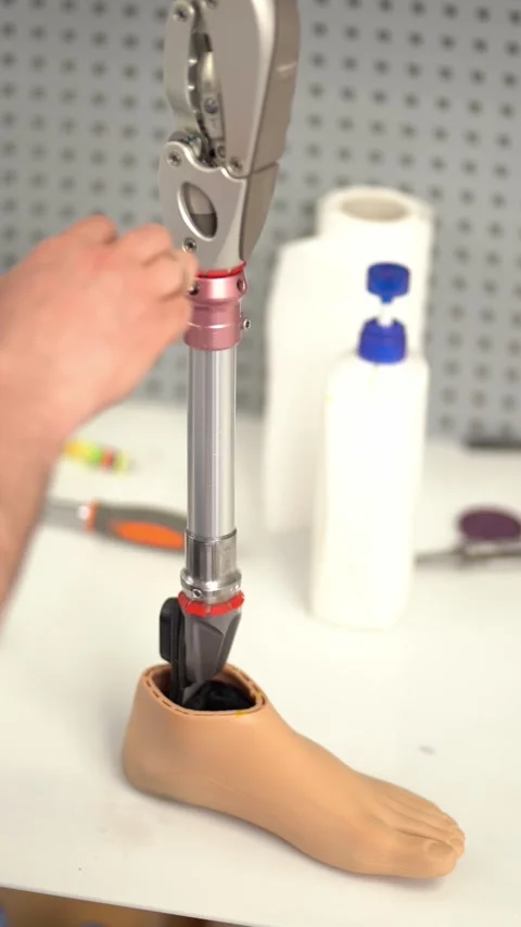 Crop man assembling prosthetic foot with screwdriver. Vertical video Stock Footage 237606289