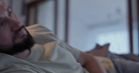 Crop man lying on sofa and using remote control Stock Footage 271159497