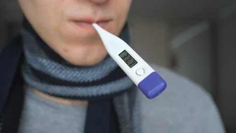 Crop man in scarf taking temperature Video stock 100817060