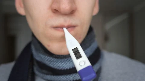 Crop man in scarf taking temperature Stock Footage 100818552