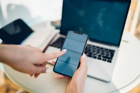 Crop man using smartphone while sitting at table Stock Photos