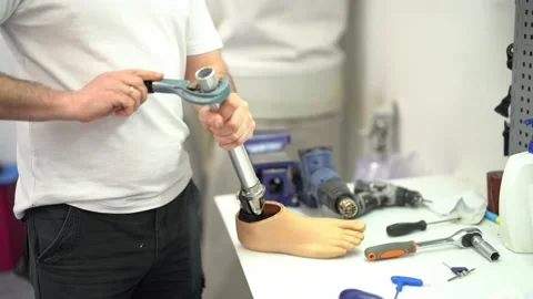 Crop master assembling prosthetic leg at workshop Stock Footage 236624109