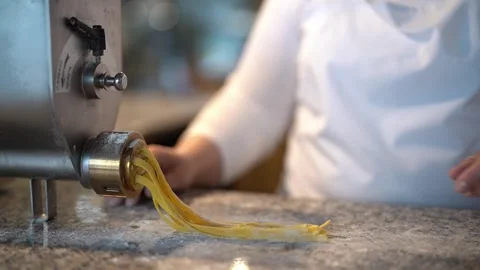 Crop master preparing pasta noodles with pasta machine Stock Footage 240414952