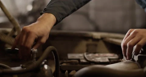 Crop mechanic fixing car engine Stock Footage 221107378