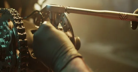Crop mechanic using breaker bar while repairing motorbike Stock Footage 265008796