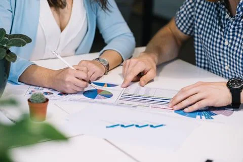 Crop people comparing data chart Stock Photos