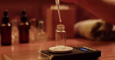 Crop perfumer measuring bottle with oil Stock Footage 260982534
