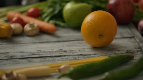 Crop person rolling orange on table Stock Footage 119687641