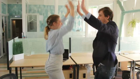 Crop side view of office workers cheering with victory and giving five to each Stock Footage 90452116