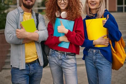 Crop students gesturing thumbs up Stock Photos