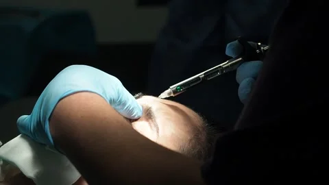 Crop surgeon injecting medication into forehead of patient Stock Footage 269341344