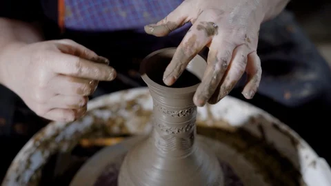 Crop talented hands of artisan creating earthenware on potter's wheel in craft Stock Footage 90161402