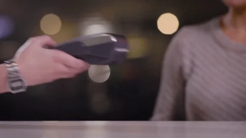 Crop view of customer and server taking payment with machine in cafe Stock Footage 81584023