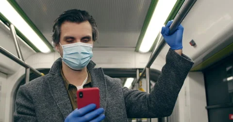 Crop view of guy in protective medical mask and latex gloves using smartphone Stock Footage 147388580
