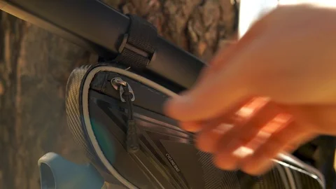 Crop view man's hand opens a bicycle bag. Stock Footage 127347585