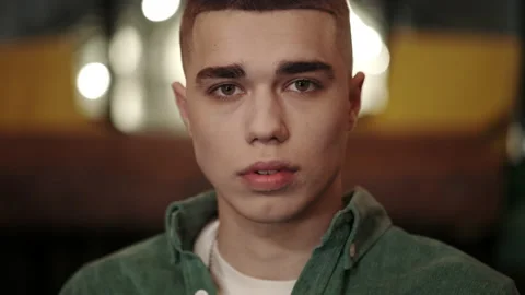 Crop view of young man with stylish haircut raising head and looking to camera Stock Footage 152286942
