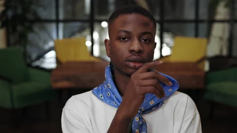 Crop view of young stylish afro american guy propping and turning head while Stock Footage 152329335