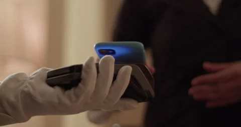 Crop woman using smartphone while paying for room service contactless Stock Footage 233187117