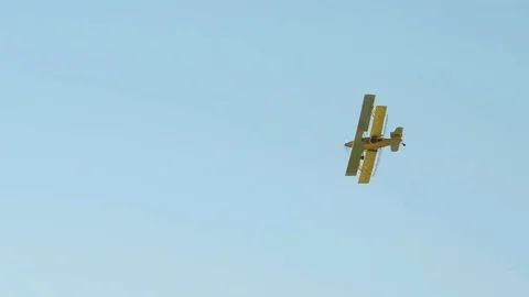 A Cropduster or Crop Duster Spraying a Field Stock Footage 78204713