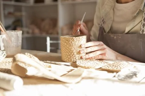 Cropped close up of ceramic mug unrecognizable woman is making at art class,  Stock Photos