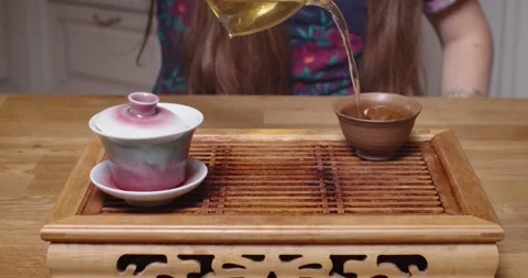 Cropped close up shot of tea master pouring tea water in bowl. Front view of man Stock Footage 150221637