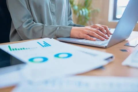 Cropped close up view of a Unrecognizable mixed race businesswoman typing an Stock Photos