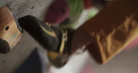 Cropped coach stepping on grip while climbing wall Stock Footage 259983164
