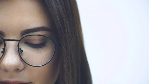 Cropped half-side face of attractive businesswoman looking down, then up at the Stock Footage 120208256
