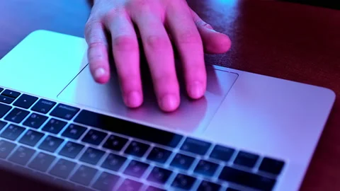 Cropped hand of a man, manipulating a touchpad on a laptop, high angle view. Stock Footage 225303001