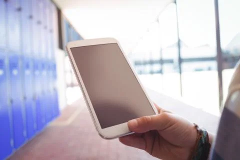 Cropped hand on student using mobile phone 写真素材