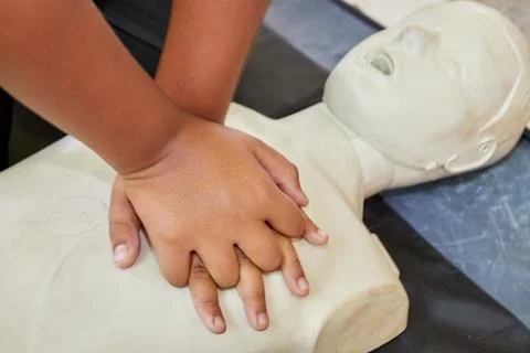Cropped hands CPR First Aid training with CPR dummy in the classroom 写真素材