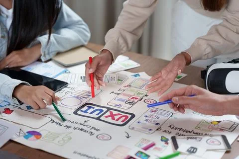 Cropped hands of creative designers wireframing mobile app layout for UX UI Stock Photos