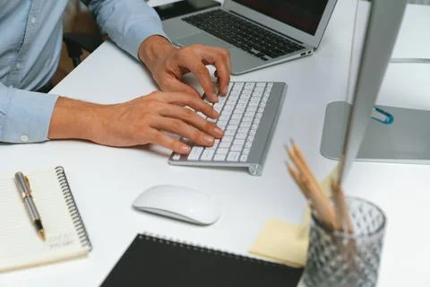 Cropped hands IT developer working online software information on pc. Pecuniary. Stock Photos