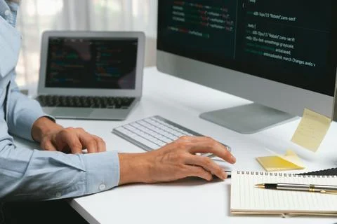 Cropped hands IT developer working online software information on pc. Pecuniary. Stockfoto's