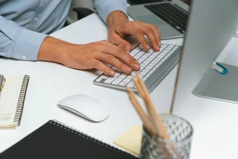 Cropped hands IT developer working online software information on pc. Pecuniary. Stockfoto's