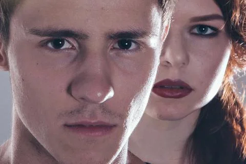 Cropped image of a beautiful couple looking at the camera standing right Stock Photos