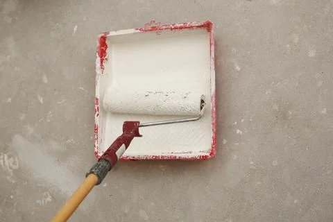 Cropped-image of a builder using paint roller in his work indoors Stock Photos