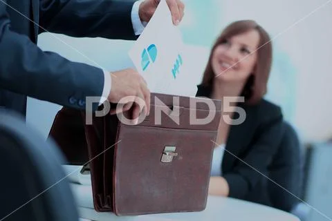 Cropped image of business woman getting documents out of briefca Stock Photos