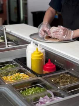 Cropped image of a chef making burrito Stock Photos