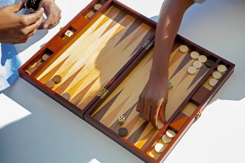 Cropped image of couple playing backgammon at home Stock Photos