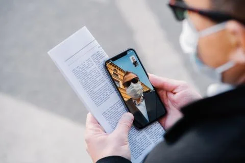 Cropped image of faceless man makes video call via modern cellphone, wears pr Foto stock