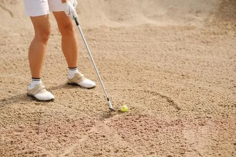 Cropped image of golf player hitting out from the bunker Stock Photos