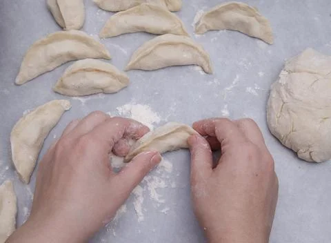 Cropped image of the hands of a child who learns to make dumplings with potatoes Stock Photos