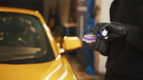 Cropped image of hands of male auto service worker in protective gloves Stock Footage 233901887